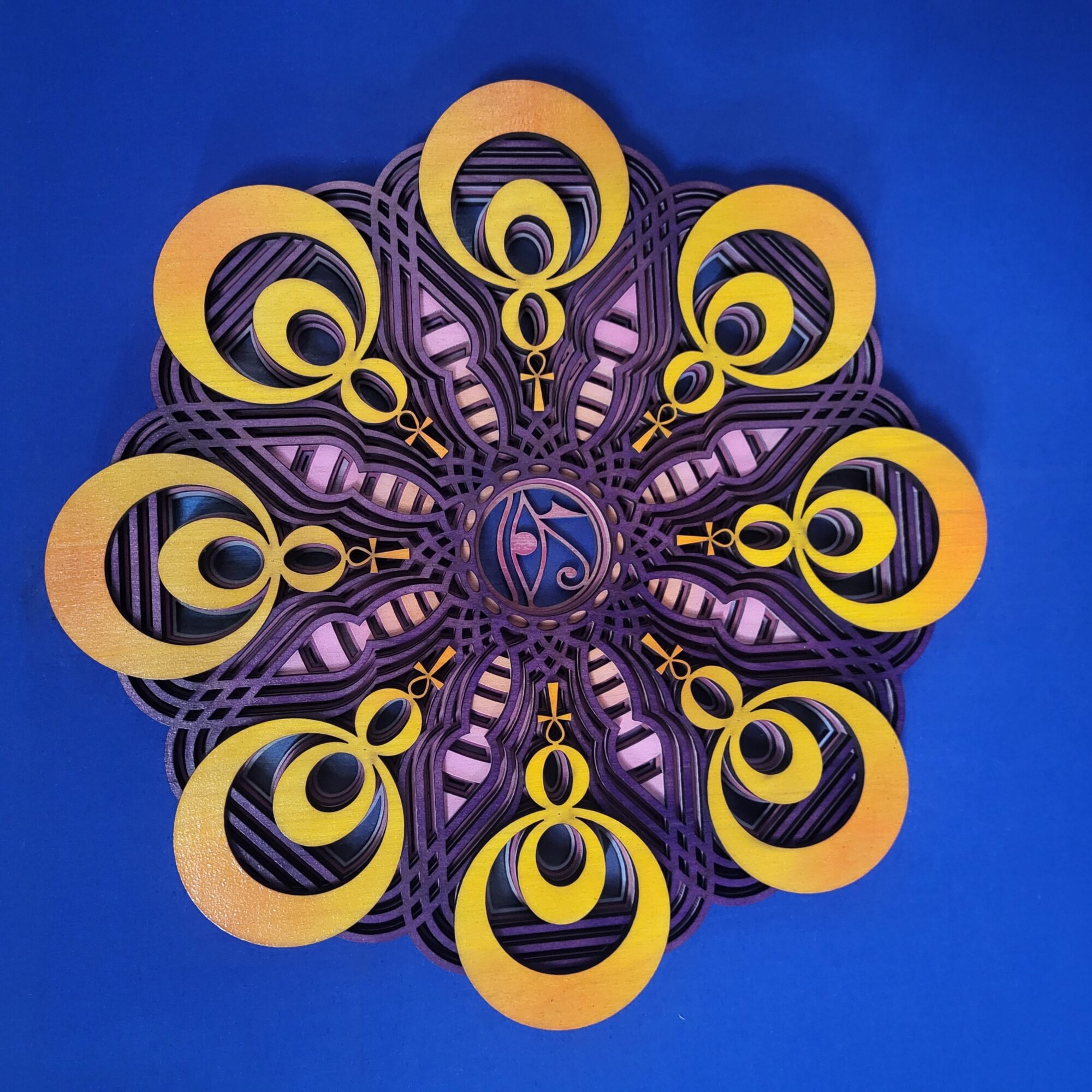 Decorative circular wall art with yellow and purple elements on a blue background.