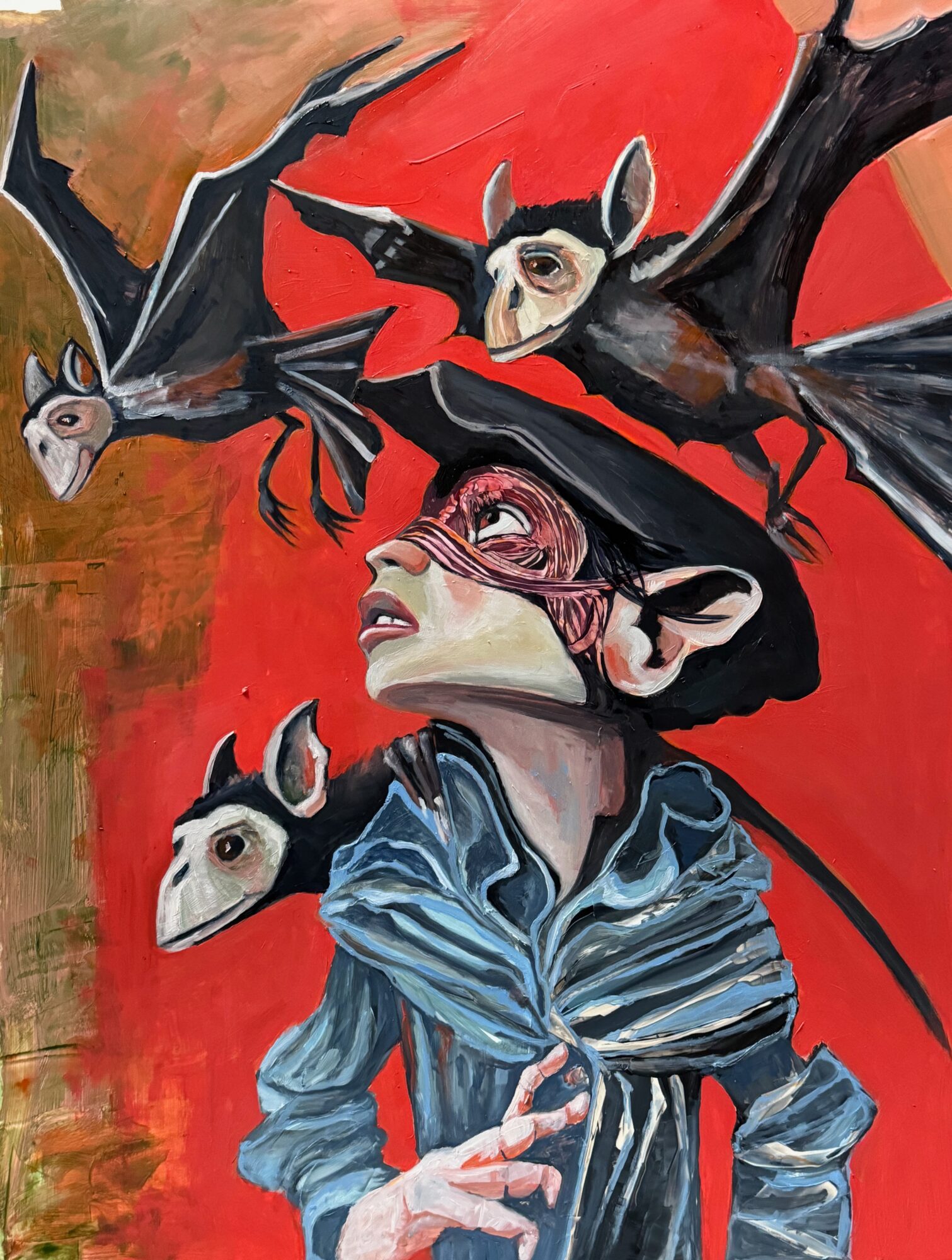 A woman with dark hair and a blue jacket is surrounded by flying bats against a red background.