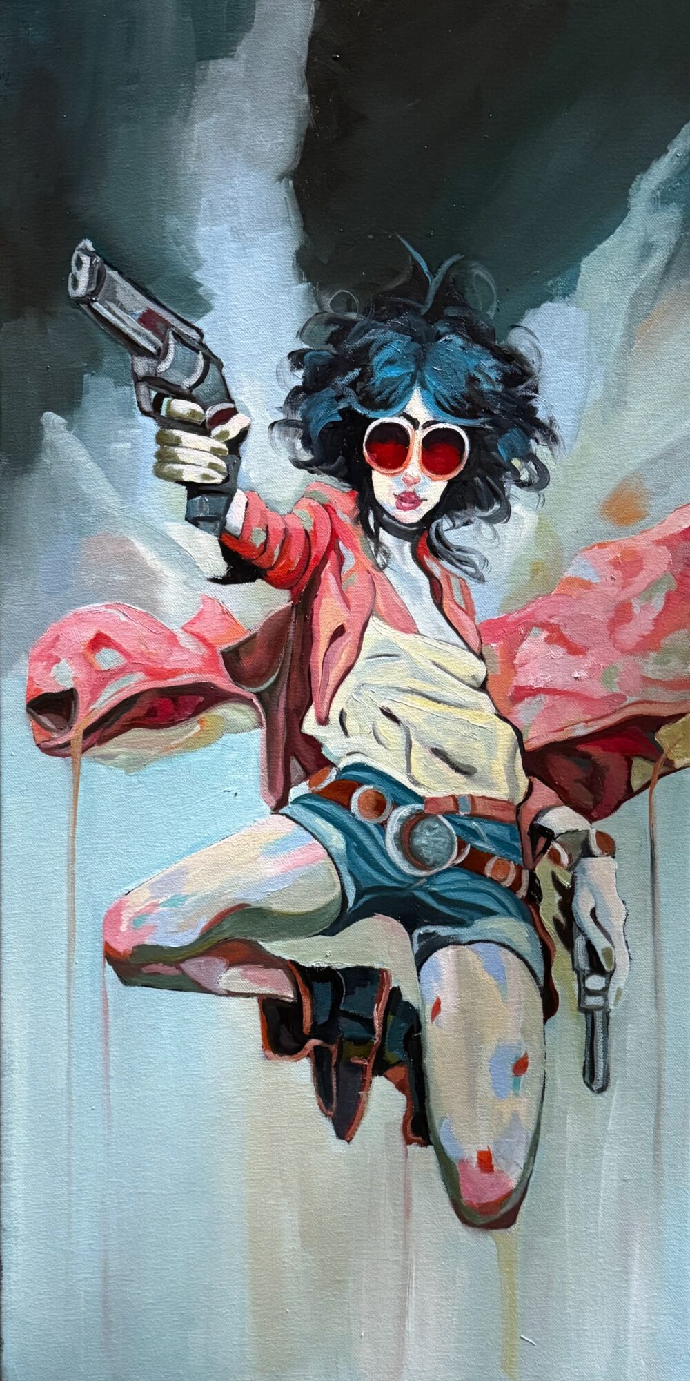 Woman with curly hair, red sunglasses, holding guns, wearing a pink jacket and shorts, against a colorful abstract background.