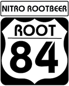 Black and white sign with text 'NITRO ROOTBEER' and a shield-shaped emblem with 'ROOT 84'.