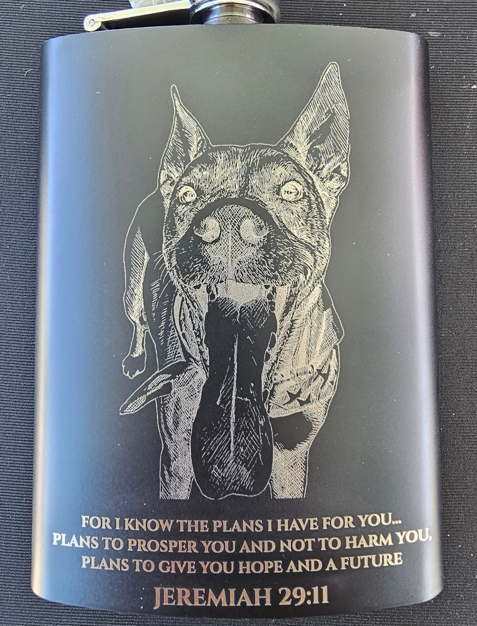 A flask with a detailed illustration of a dog's face, and a quote from Jeremiah 29:11 at the bottom.
