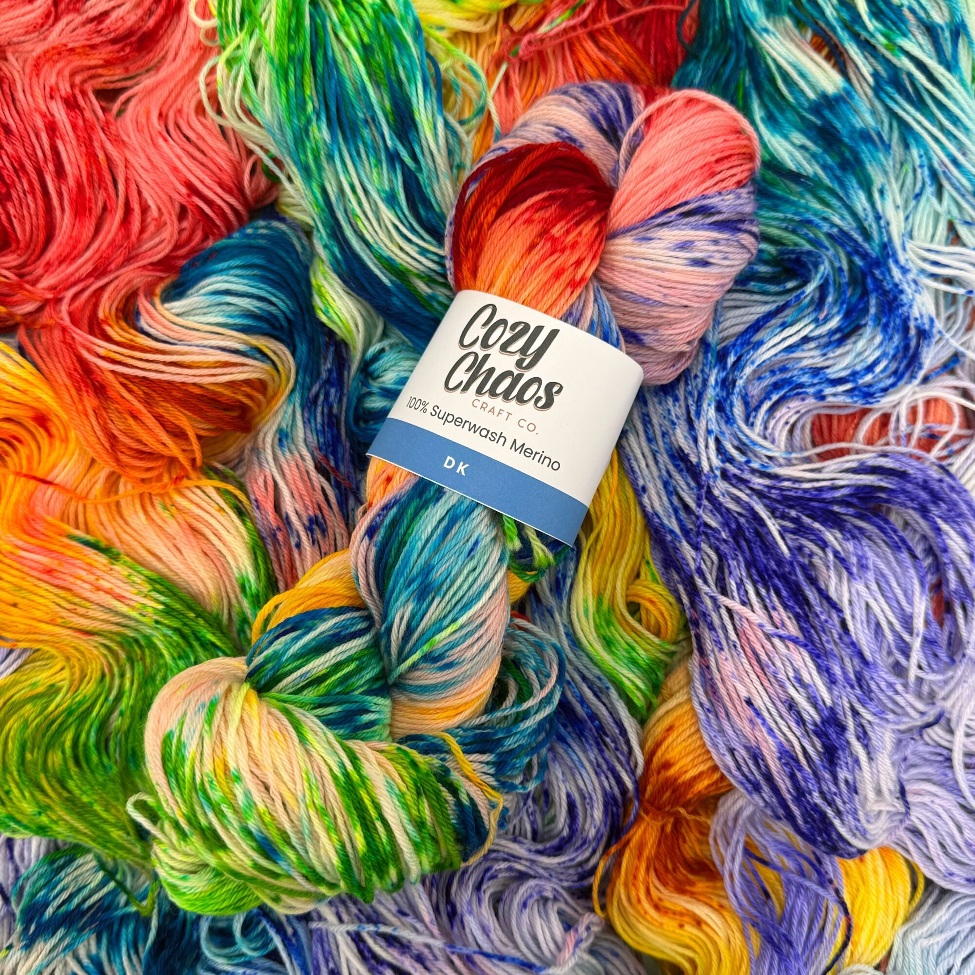 Colorful yarns in various shades and patterns, with a skein labeled 