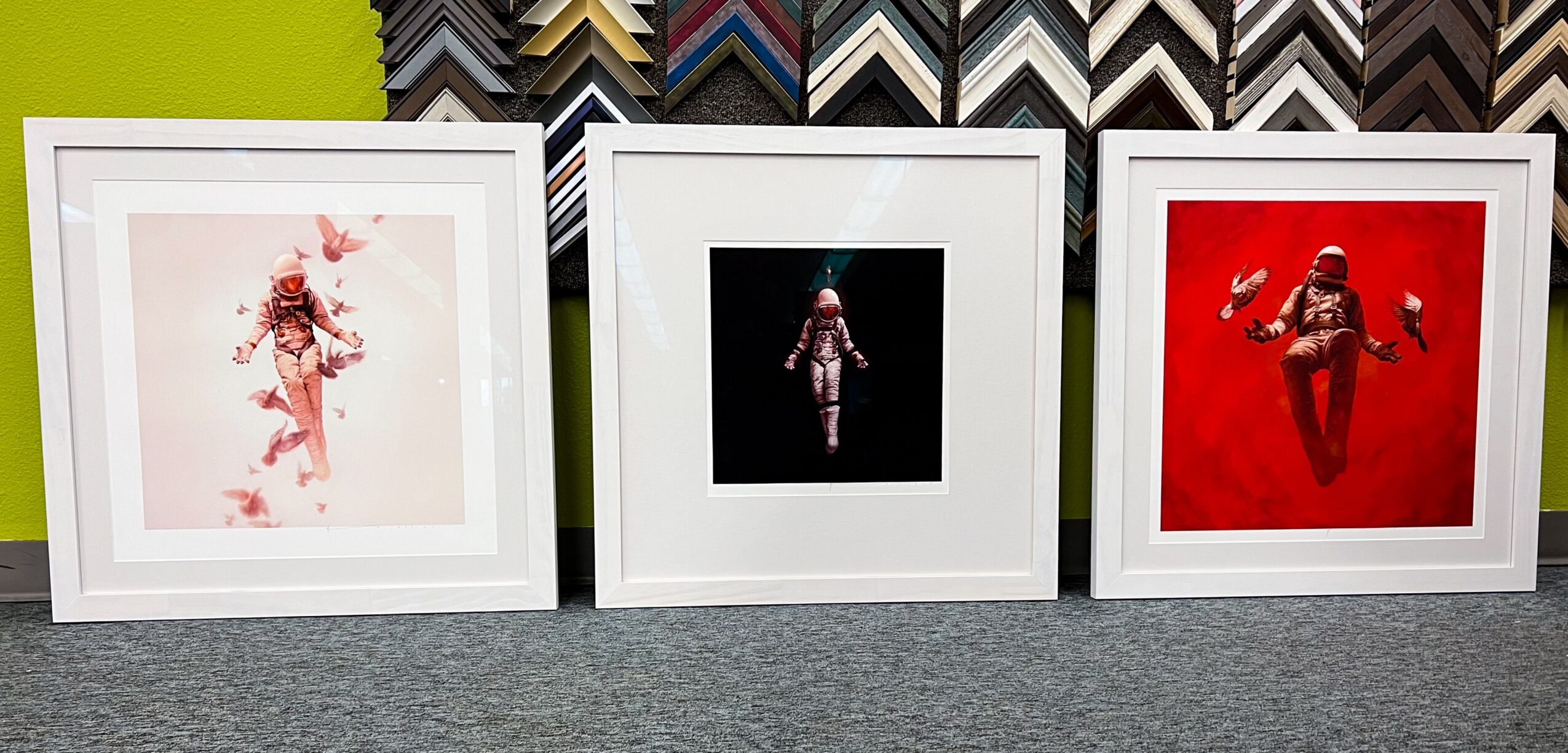 Three framed artworks displayed on a wall, each featuring a person in different poses and backgrounds.