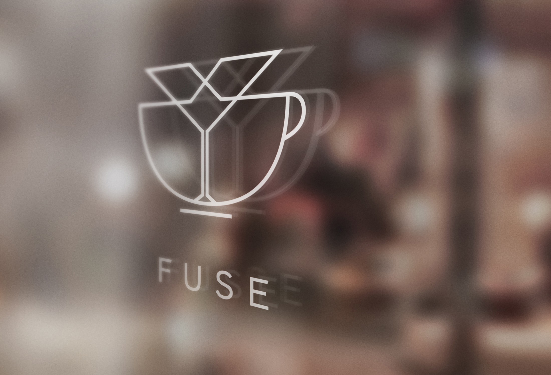 Glass with martini and coffee cup icons, and the word FUSE below, on a blurred background.