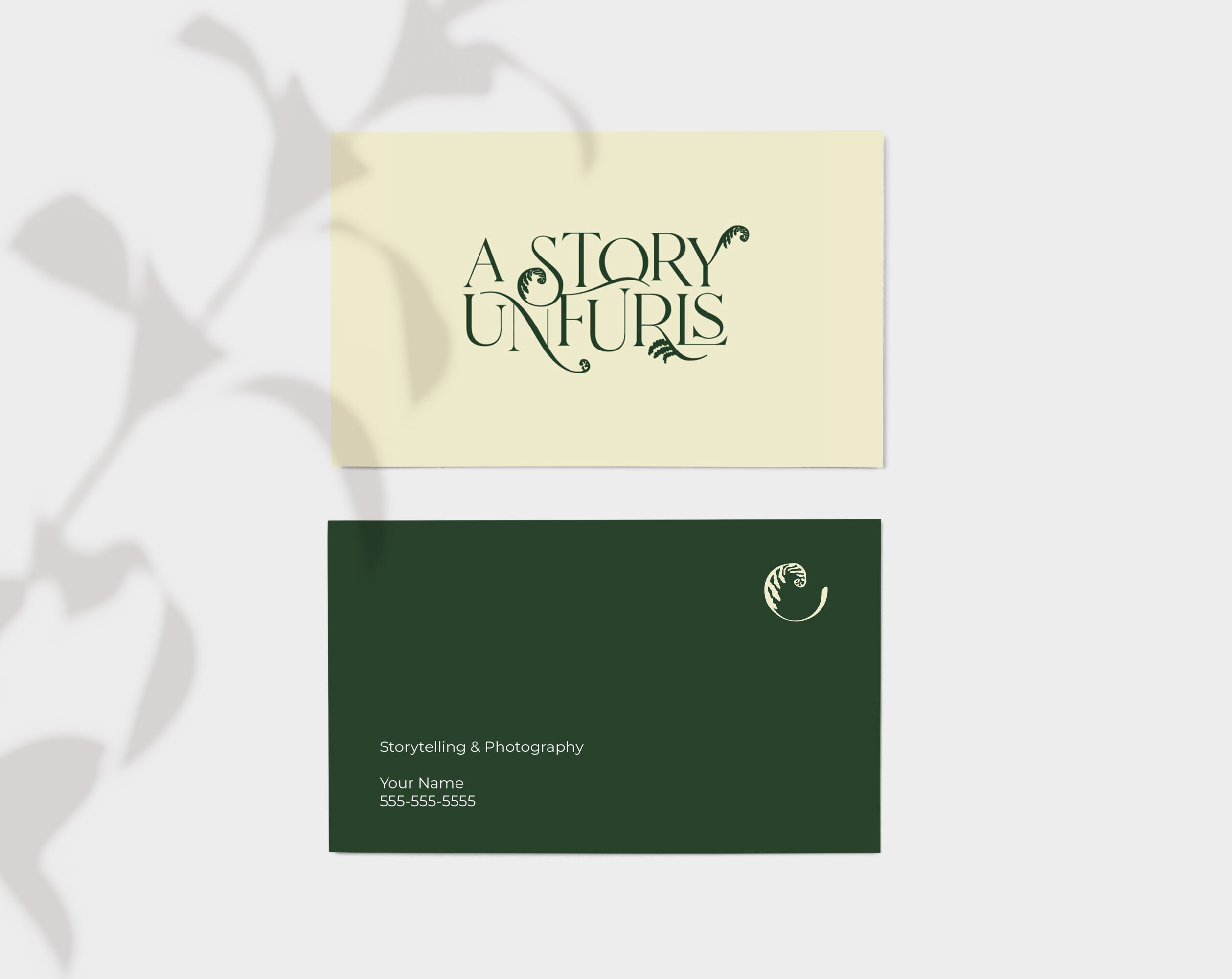 Two business cards, one with the text 'A STORY UNFURLS' and the other with contact information, on a light background.